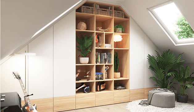 Bibliothèque en bois clair avec étagères remplies de livres, plantes et objets décoratifs dans une pièce mansardée lumineuse avec fenêtre de toit.